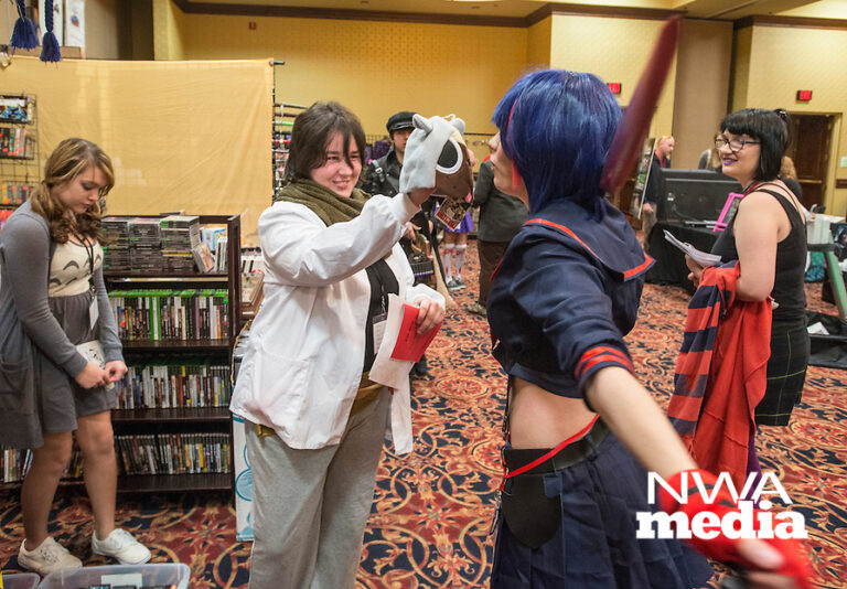 NWA Democrat-Gazette/ANTHONY REYES ¥ @NWATONYR
Sadie Gilliam of Harrison shows Shai Percy of Mountain Home a novelty cap Friday, Nov. 13, 2015 during the Arkansas Anime Festival at the Holiday Inn in Springdale. Gilliam is dressed as Nagi Kengamine from the "Deadman Wonderland" series and Percy is dressed as Ry?ko Matoi from the Kill la Kill series. Many attendees of the festival are participating in cosplay. The festival continues today (Saturday) and Sunday from starting at 10 a.m. both days. The event features vendors, live demonstrations and talks about subjects including gaming, costume construction among other topics.
